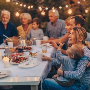 Get a Head Start on Thanksgiving Preparations: photo of a family at large table filled with thanksgiving food staples